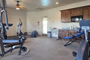 Exercise area with ceiling fan and recessed lighting
