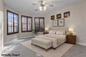 Casita with a ceiling fan and multiple windows. Virtually staged.
