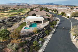 Aerial overview of property's location with mountains and nearby suburban area