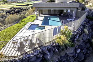 View of pool featuring a patio and a pool with connected hot tub.
