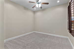 Spare room featuring light carpet, recessed lighting, and a ceiling fan