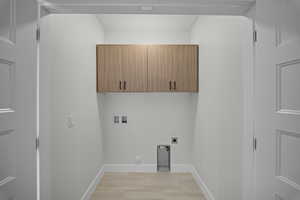 Laundry room featuring washer hookup, cabinet space, electric dryer hookup, and gas dryer hookup