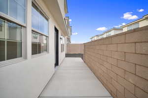 View of side of property with a fenced backyard and stucco siding