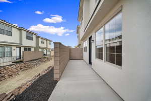View of side of property featuring stucco siding and a residential view