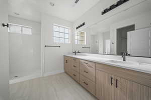 Full bathroom with a stall shower and double vanity