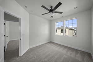 Unfurnished room featuring light carpet and ceiling fan