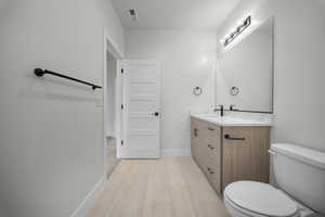 Bathroom featuring vanity and baseboards