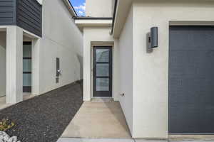 Entrance to property featuring stucco siding