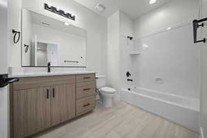 Bathroom featuring vanity, shower / tub combination, and recessed lighting