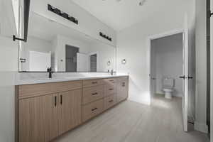 Bathroom featuring double vanity and toilet