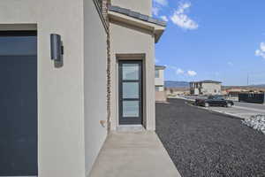 Property entrance featuring stucco siding and a mountain view