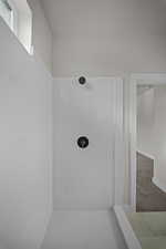 Bathroom with a shower and carpet