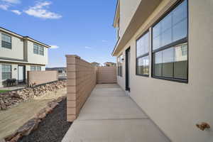 View of home's exterior with stucco siding and a patio