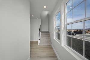 Stairway featuring recessed lighting and wood finished floors