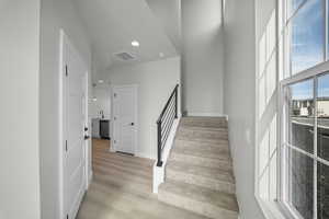Staircase featuring recessed lighting and wood finished floors