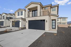 Contemporary home with stucco siding, a balcony, concrete driveway, an attached garage, and a tiled roof