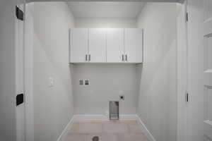 Laundry area featuring hookup for a washing machine, cabinet space, hookup for an electric dryer, light tile patterned flooring, and hookup for a gas dryer