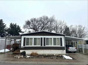 View of front of house with a carport, driveway, and a porch