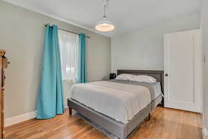 Bedroom featuring light wood finished floors and baseboards
