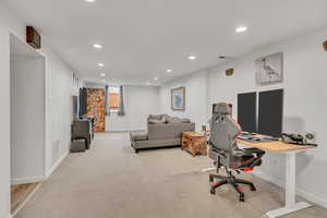 Home office featuring recessed lighting and light colored carpet