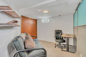 Office with light colored carpet and baseboards