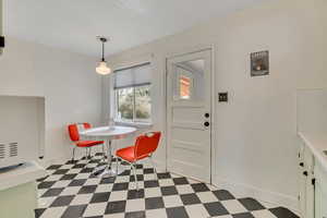 Dining space featuring light floors and baseboards