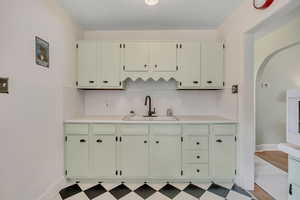 Kitchen with light countertops, tasteful backsplash, and light floors