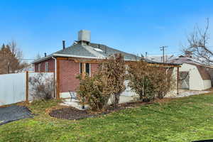 View of side of home featuring brick siding and a shingled roof