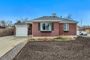 View of front of property with roof with shingles, brick siding, concrete driveway, and a garage