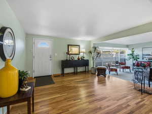 Foyer featuring wood finished floors and baseboards