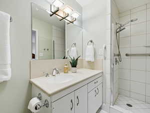 Bathroom featuring vanity and a stall shower