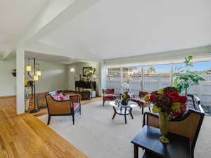 Living area featuring hardwood / wood-style flooring and baseboards