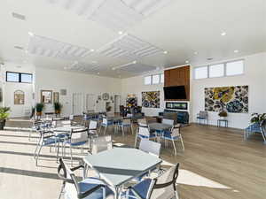 Dining area with a high ceiling, light wood-type flooring, and recessed lighting