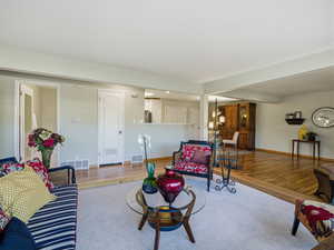 Living area featuring baseboards and wood finished floors