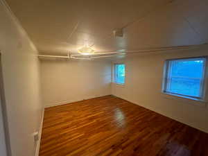 Unit 5 Empty room featuring wood finished floors