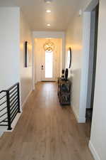 Doorway featuring hardwood / wood-style flooring, a chandelier, and recessed lighting