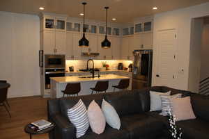 Living room featuring dark wood finished floors and recessed lighting