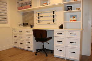 Office space with light wood finished floors and baseboards