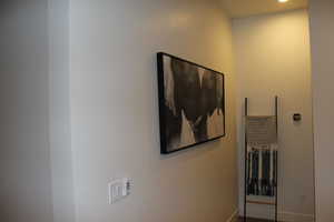 Hall with baseboards and recessed lighting