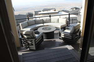 Balcony featuring an outdoor living space with a fire pit