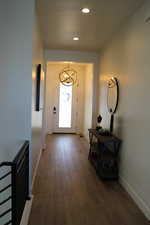 Foyer featuring a chandelier, wood-type flooring, and recessed lighting