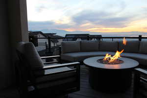 Deck at dusk with an outdoor living space with a fire pit and a mountain view