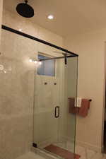 Bathroom with a shower stall and recessed lighting
