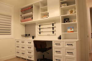 Home office with light wood-style floors and baseboards