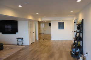 Living room featuring wood finished floors and recessed lighting