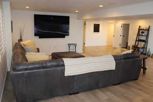 Living room with light wood-style floors and recessed lighting