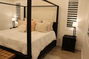 Bedroom with light wood-style floors and baseboards