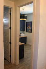 Hallway with dark wood finished floors and baseboards