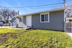 View of front of house with an outbuilding and a garage