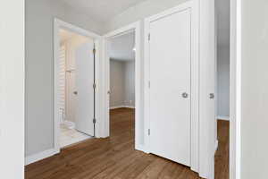 Hall featuring light wood-style floors and baseboards